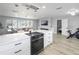 Open-concept kitchen with stainless steel appliances, a dining area, and a living room view, perfect for entertaining and Gathering gatherings at 200 98Th Ne Ave, St Petersburg, FL 33702