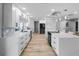 Modern kitchen with white cabinetry, marble countertops, stainless steel appliances, and a stylish backsplash, creating a sleek and functional space at 200 98Th Ne Ave, St Petersburg, FL 33702