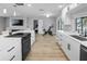Bright kitchen with a living room view, white cabinetry, stainless steel appliances, and an open layout for easy entertaining at 200 98Th Ne Ave, St Petersburg, FL 33702