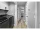 Modern laundry room featuring updated washer and dryer units and overhead storage cabinets at 200 98Th Ne Ave, St Petersburg, FL 33702