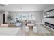 Modern living room featuring stylish furniture, large windows for natural light, and sleek fireplace with a marble surround at 200 98Th Ne Ave, St Petersburg, FL 33702