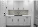 Convenient mudroom with white cabinetry, a counter, and marble backsplash, ideal for storage at 200 98Th Ne Ave, St Petersburg, FL 33702