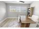 Bright and airy office space featuring a large desk, comfortable chair, and a window with a view at 200 98Th Ne Ave, St Petersburg, FL 33702