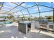 Outdoor kitchen and entertaining area with a built-in grill and granite countertops at 200 98Th Ne Ave, St Petersburg, FL 33702