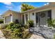 Inviting front entrance with decorative wreath and lush greenery around the well-lit front door at 2029 Winding Oaks Dr, Palm Harbor, FL 34683