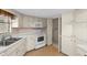 Functional kitchen with white appliances and cabinets, offering plenty of storage at 2029 Winding Oaks Dr, Palm Harbor, FL 34683
