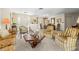 Open living space with comfortable seating, opening up to the dining area at 2029 Winding Oaks Dr, Palm Harbor, FL 34683