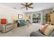 Comfortable living room with ceiling fan and sliding glass doors to the pool area at 2029 Winding Oaks Dr, Palm Harbor, FL 34683
