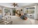 Bright living room with sliding glass doors leading to the screened pool area at 2029 Winding Oaks Dr, Palm Harbor, FL 34683