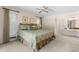 Comfortable main bedroom with ensuite bathroom and a view to the windows and closet at 2029 Winding Oaks Dr, Palm Harbor, FL 34683