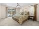 Bright main bedroom with access to the pool area, neutral decor, and a ceiling fan at 2029 Winding Oaks Dr, Palm Harbor, FL 34683