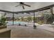 Covered patio overlooking the sparkling pool area, perfect for outdoor entertaining at 2029 Winding Oaks Dr, Palm Harbor, FL 34683