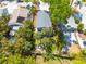 Aerial view of a property showcasing a fenced backyard, mature landscaping, and a patio with outdoor seating at 224 Ontario Ave, Crystal Beach, FL 34681