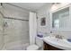 Bathroom with shower-tub combo and dark wood vanity with a modern sink at 224 Ontario Ave, Crystal Beach, FL 34681
