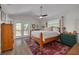 Bright bedroom featuring a ceiling fan, wooden accents, and access to an outdoor deck at 224 Ontario Ave, Crystal Beach, FL 34681