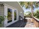 Exterior deck with a small table and dark wood floor at 224 Ontario Ave, Crystal Beach, FL 34681
