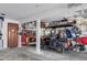 Spacious garage featuring a golf cart, storage solutions, and a wooden door with a porthole window at 224 Ontario Ave, Crystal Beach, FL 34681