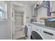 Functional laundry room with washer, dryer, and plenty of storage space, and access to a bathroom at 224 Ontario Ave, Crystal Beach, FL 34681