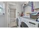 Laundry room with a washer, dryer, storage and leads to a full bathroom at 224 Ontario Ave, Crystal Beach, FL 34681