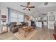 Bright living room with wood floors, a ceiling fan, and a comfortable seating area at 224 Ontario Ave, Crystal Beach, FL 34681