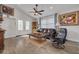 Cozy living room with wood floors, ceiling fan, and plenty of natural light at 224 Ontario Ave, Crystal Beach, FL 34681