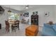 Comfortable living room featuring a dining table, cozy furniture, and large windows at 224 Ontario Ave, Crystal Beach, FL 34681