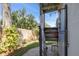 Outdoor shower featuring a privacy curtain, stone pathway, and adjacent tropical greenery for a spa-like experience at 224 Ontario Ave, Crystal Beach, FL 34681