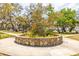 Stone bordered flower and tree feature in a community park and sidewalk at 224 Ontario Ave, Crystal Beach, FL 34681