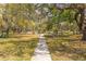 Sidewalk and park area in a community, lush green space with benches at 224 Ontario Ave, Crystal Beach, FL 34681