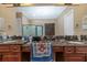 Spacious bathroom with double vanity, marble countertop, dark wood cabinets, and frameless glass shower at 2630 Grand Lakeside Dr, Palm Harbor, FL 34684