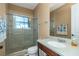 Bathroom featuring a glass-enclosed shower and a vanity with solid surface countertop at 2630 Grand Lakeside Dr, Palm Harbor, FL 34684