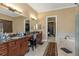 Bathroom with double vanity, a large mirror, and an entrance to walk-in closet at 2630 Grand Lakeside Dr, Palm Harbor, FL 34684