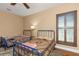 Cozy bedroom featuring twin beds, wood floors and natural light from shuttered windows at 2630 Grand Lakeside Dr, Palm Harbor, FL 34684