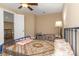 Comfortable bedroom featuring two beds, a ceiling fan and views of the foyer at 2630 Grand Lakeside Dr, Palm Harbor, FL 34684