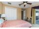 Inviting bedroom showcasing large closet and access to screened patio with picturesque outdoor views at 2630 Grand Lakeside Dr, Palm Harbor, FL 34684