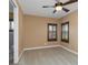 Cozy bedroom with neutral walls, carpet floors, and shuttered windows at 2630 Grand Lakeside Dr, Palm Harbor, FL 34684