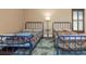 Bedroom with two twin beds, shuttered windows providing natural light, and hardwood floors at 2630 Grand Lakeside Dr, Palm Harbor, FL 34684