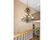 Grand foyer featuring a decorative chandelier and a view of the second-floor railing at 2630 Grand Lakeside Dr, Palm Harbor, FL 34684