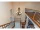 Magnificent foyer showcasing a wrought iron chandelier, hardwood floors, and a spacious open layout at 2630 Grand Lakeside Dr, Palm Harbor, FL 34684