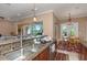 Kitchen features a granite countertop, stainless steel sink, and views of the living room and breakfast nook at 2630 Grand Lakeside Dr, Palm Harbor, FL 34684