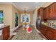 Spacious kitchen features granite counters, wooden cabinetry, and a view to the backyard and breakfast nook at 2630 Grand Lakeside Dr, Palm Harbor, FL 34684