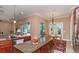 Kitchen features granite countertops, wooden cabinetry, stainless appliances, and a view to the backyard and breakfast nook at 2630 Grand Lakeside Dr, Palm Harbor, FL 34684