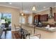 Kitchen bar with granite countertop and pendant lighting provides seating and overlooks the outdoor patio at 2630 Grand Lakeside Dr, Palm Harbor, FL 34684