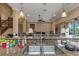 Kitchen features a granite countertop, stainless steel sink, and views of the living room and breakfast nook at 2630 Grand Lakeside Dr, Palm Harbor, FL 34684