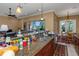 Kitchen features a granite countertop, stainless steel sink, and views of the living room and breakfast nook at 2630 Grand Lakeside Dr, Palm Harbor, FL 34684