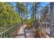 Lush landscaping with a brick pathway leads to the screened-in pool, creating a tranquil outdoor space at 2630 Grand Lakeside Dr, Palm Harbor, FL 34684