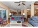 Spacious living room featuring hardwood floors and an open layout flowing into the kitchen at 2630 Grand Lakeside Dr, Palm Harbor, FL 34684