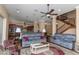 Inviting living room with hardwood floors, a ceiling fan, and open access to the kitchen and staircase at 2630 Grand Lakeside Dr, Palm Harbor, FL 34684