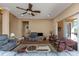 Bright living area with hardwood floors, a ceiling fan, and large sliding glass doors to the patio at 2630 Grand Lakeside Dr, Palm Harbor, FL 34684