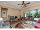 Bright living area with hardwood floors, a ceiling fan, and large sliding glass doors to the patio at 2630 Grand Lakeside Dr, Palm Harbor, FL 34684